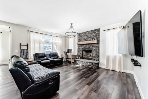6 Emberside Green, Cochrane, AB - Indoor Photo Showing Living Room With Fireplace