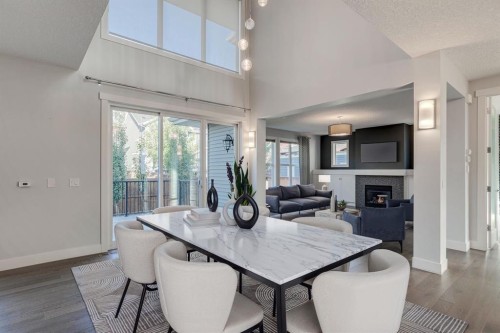 427 Canals Boulevard Sw, Airdrie, AB - Indoor Photo Showing Dining Room With Fireplace