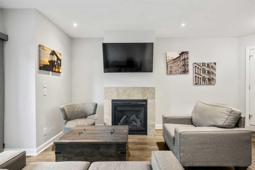 2-530 56 Avenue Sw, Calgary, AB - Indoor Photo Showing Living Room With Fireplace
