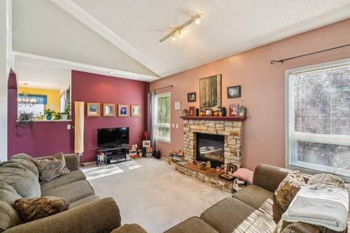 142 Elizabeth Way Se, Airdrie, AB - Indoor Photo Showing Living Room With Fireplace