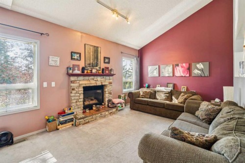 142 Elizabeth Way Se, Airdrie, AB - Indoor Photo Showing Living Room With Fireplace