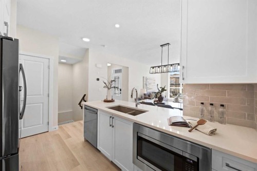2150 Bayview Drive Sw, Airdrie, AB - Indoor Photo Showing Kitchen With Double Sink With Upgraded Kitchen