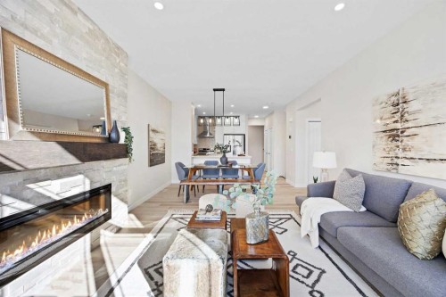 2150 Bayview Drive Sw, Airdrie, AB - Indoor Photo Showing Living Room With Fireplace
