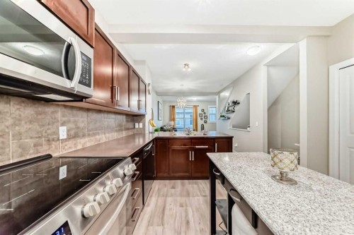 49 New Brighton Point Se, Calgary, AB - Indoor Photo Showing Kitchen With Double Sink With Upgraded Kitchen