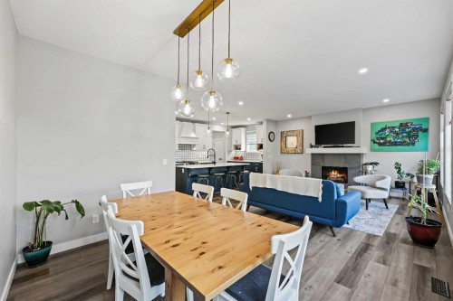 34 Coach Ridge Point Sw, Calgary, AB - Indoor Photo Showing Dining Room With Fireplace