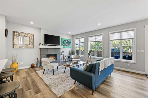 34 Coach Ridge Point Sw, Calgary, AB - Indoor Photo Showing Living Room With Fireplace