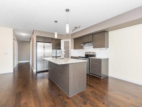 202-15207 1 Street Se, Calgary, AB - Indoor Photo Showing Kitchen With Upgraded Kitchen
