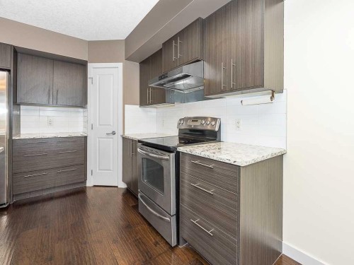 202-15207 1 Street Se, Calgary, AB - Indoor Photo Showing Kitchen With Stainless Steel Kitchen With Upgraded Kitchen