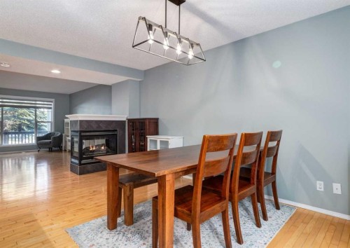 137 Tuscany Springs Way Nw, Calgary, AB - Indoor Photo Showing Dining Room With Fireplace