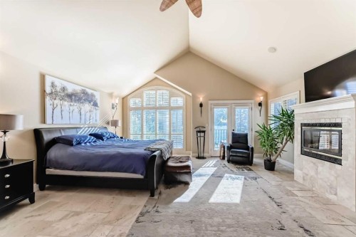 716 West Chestermere Drive, Chestermere, AB - Indoor Photo Showing Bedroom With Fireplace