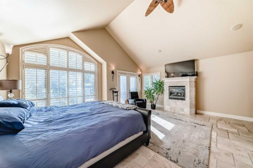 716 West Chestermere Drive, Chestermere, AB - Indoor Photo Showing Bedroom With Fireplace
