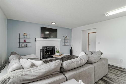 347 Whitefield Drive Ne, Calgary, AB - Indoor Photo Showing Living Room With Fireplace