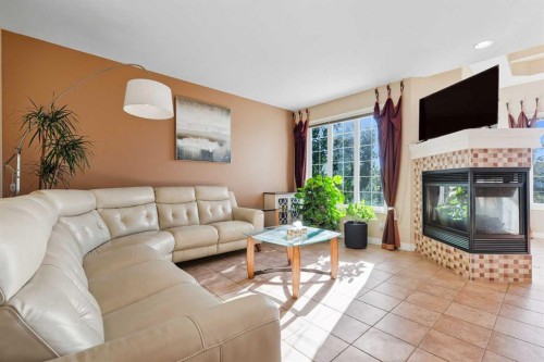 7 Panatella Close Nw, Calgary, AB - Indoor Photo Showing Living Room With Fireplace