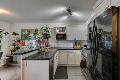 51 Spring Meadows Bay, Okotoks, AB - Indoor Photo Showing Kitchen With Double Sink