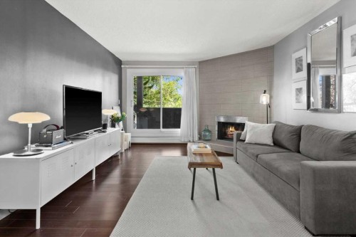 205-1001 68 Avenue Sw, Calgary, AB - Indoor Photo Showing Living Room With Fireplace