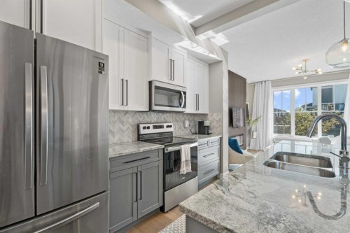 332 Lawthorn Way Se, Airdrie, AB - Indoor Photo Showing Kitchen With Double Sink With Upgraded Kitchen