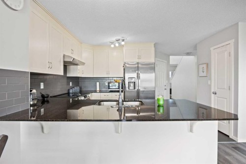 180 Panatella Way Nw, Calgary, AB - Indoor Photo Showing Kitchen With Upgraded Kitchen