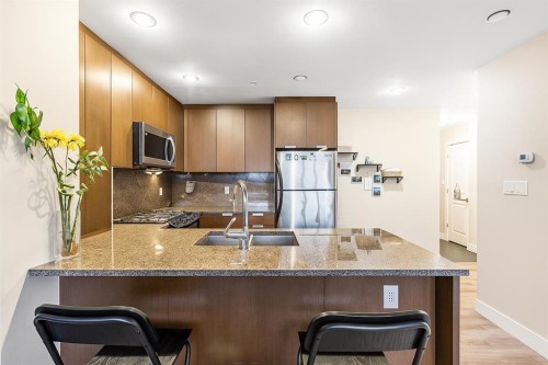 1403-99 Spruce Place Sw, Calgary, AB - Indoor Photo Showing Kitchen With Double Sink