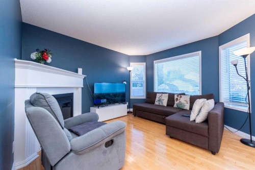 49 Rocky Ridge Heath Nw, Calgary, AB - Indoor Photo Showing Living Room With Fireplace