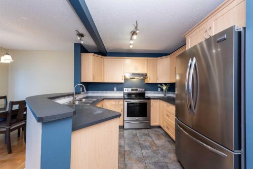 49 Rocky Ridge Heath Nw, Calgary, AB - Indoor Photo Showing Kitchen With Double Sink