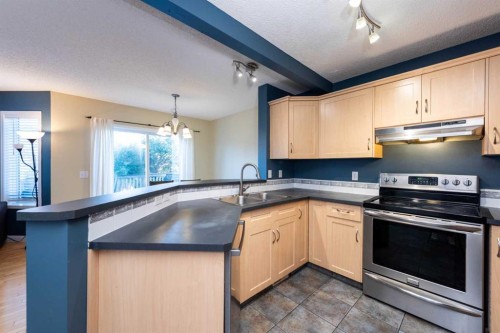 49 Rocky Ridge Heath Nw, Calgary, AB - Indoor Photo Showing Kitchen With Double Sink