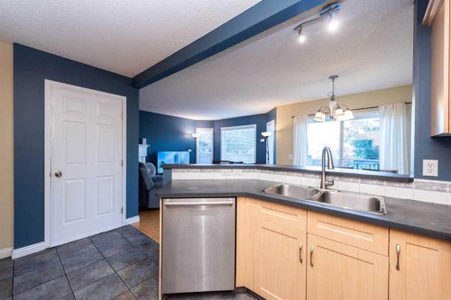 49 Rocky Ridge Heath Nw, Calgary, AB - Indoor Photo Showing Kitchen With Double Sink