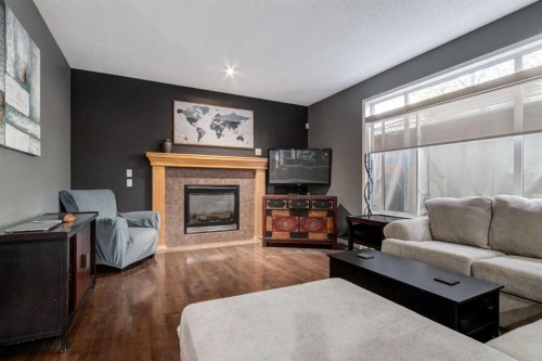 10 Chapala Road Se, Calgary, AB - Indoor Photo Showing Living Room With Fireplace