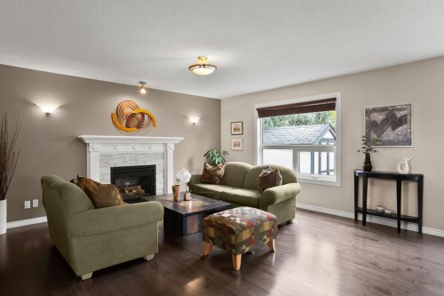 20 Tuscarora Place Nw, Calgary, AB - Indoor Photo Showing Living Room With Fireplace