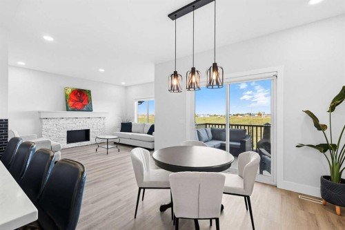 78 Copperpond Street Se, Calgary, AB - Indoor Photo Showing Dining Room With Fireplace