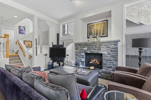 153-13 Aspen Glen, Canmore, AB - Indoor Photo Showing Living Room With Fireplace