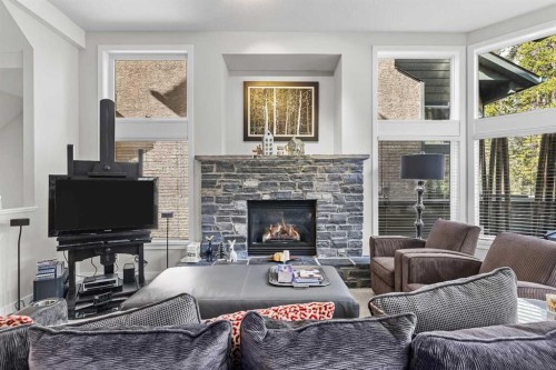 153-13 Aspen Glen, Canmore, AB - Indoor Photo Showing Living Room With Fireplace