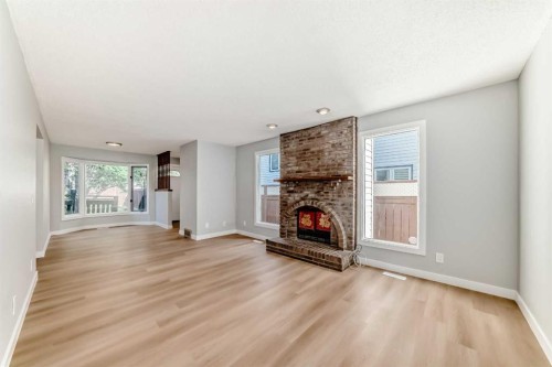 656 Woodbine Boulevard Sw, Calgary, AB - Indoor Photo Showing Living Room With Fireplace