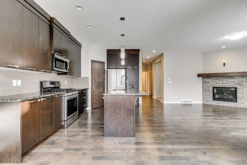 2107 Brightoncrest Green Se, Calgary, AB - Indoor Photo Showing Kitchen With Fireplace With Upgraded Kitchen