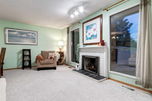 220 Oakridge Place Sw, Calgary, AB - Indoor Photo Showing Living Room With Fireplace