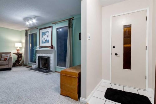 220 Oakridge Place Sw, Calgary, AB - Indoor Photo Showing Other Room With Fireplace