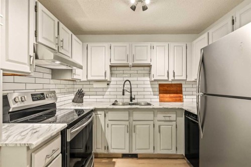 109-200 Three Sisters Drive, Canmore, AB - Indoor Photo Showing Kitchen With Stainless Steel Kitchen With Double Sink With Upgraded Kitchen