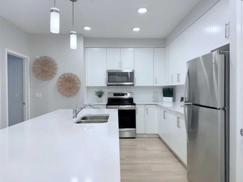 310-20 Mahogany Mews Se, Calgary, AB - Indoor Photo Showing Kitchen With Stainless Steel Kitchen With Double Sink
