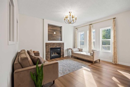 366 Bridleridge View Sw, Calgary, AB - Indoor Photo Showing Living Room With Fireplace