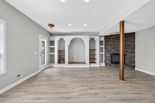 159 Hidden Ranch Circle Nw, Calgary, AB - Indoor Photo Showing Other Room With Fireplace