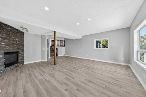 159 Hidden Ranch Circle Nw, Calgary, AB - Indoor Photo Showing Living Room With Fireplace