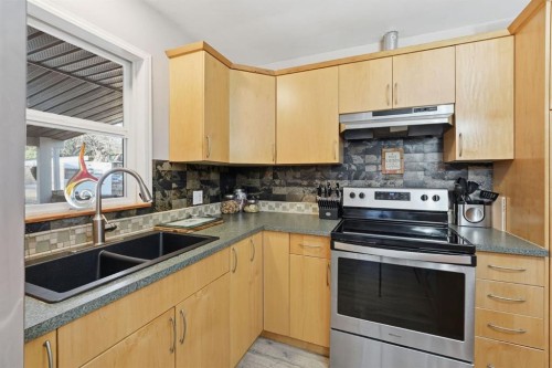 74 Mcrae Street East, Okotoks, AB - Indoor Photo Showing Kitchen With Double Sink