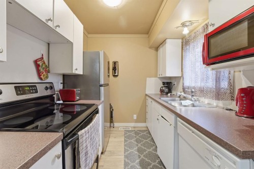 74 Mcrae Street East, Okotoks, AB - Indoor Photo Showing Kitchen With Double Sink