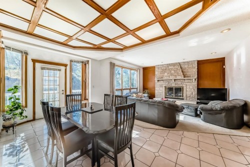 17 Santana Manor Nw, Calgary, AB - Indoor Photo Showing Dining Room With Fireplace