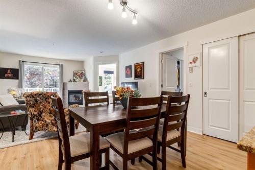216-2233 34 Avenue Sw, Calgary, AB - Indoor Photo Showing Dining Room With Fireplace