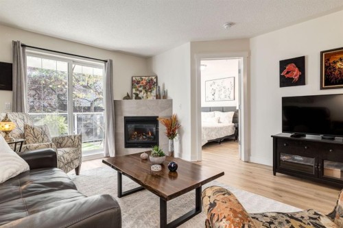 216-2233 34 Avenue Sw, Calgary, AB - Indoor Photo Showing Living Room With Fireplace