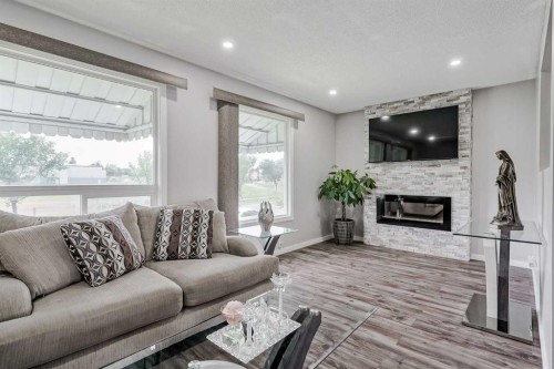 4108 Marlborough Drive Ne, Calgary, AB - Indoor Photo Showing Living Room With Fireplace