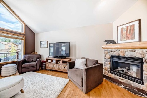 12-903 Wilson Way, Canmore, AB - Indoor Photo Showing Living Room With Fireplace