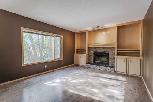 135 Canterbury Court Sw, Calgary, AB - Indoor Photo Showing Living Room With Fireplace