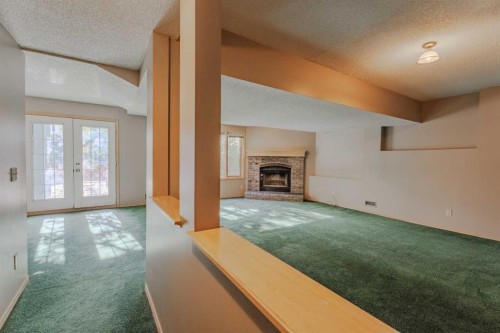 135 Canterbury Court Sw, Calgary, AB - Indoor Photo Showing Other Room With Fireplace