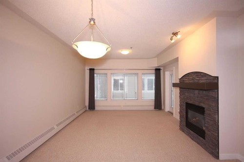 518-30 Discovery Ridge Close Sw, Calgary, AB - Indoor Photo Showing Other Room With Fireplace